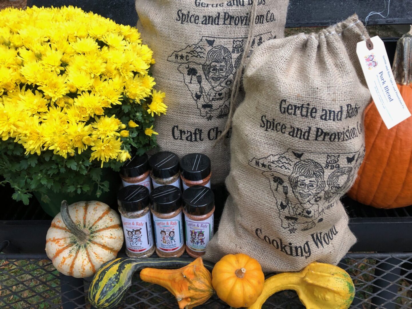 Gourds, flowers, and sacks of Gertie and Ray's spices.